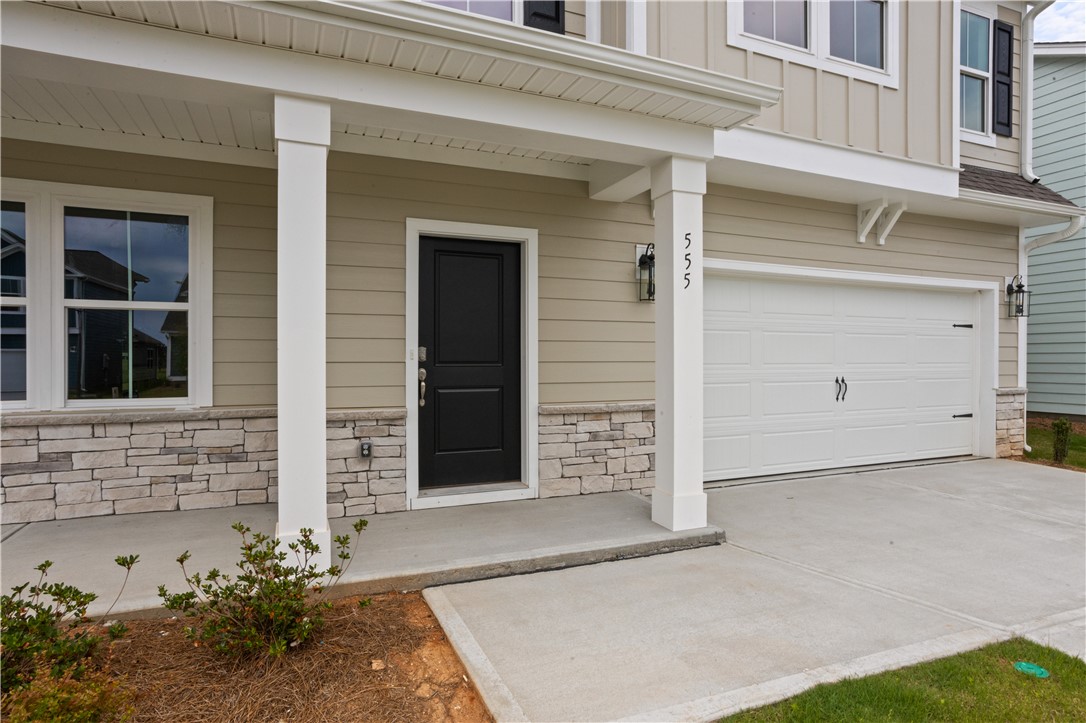555 Hydrangea Street, Unit LOT 47 Seneca, SC 29678 - Photo 3 of 38 A welcoming covered porch and garage entrance feature durable stone accents and clean lines.