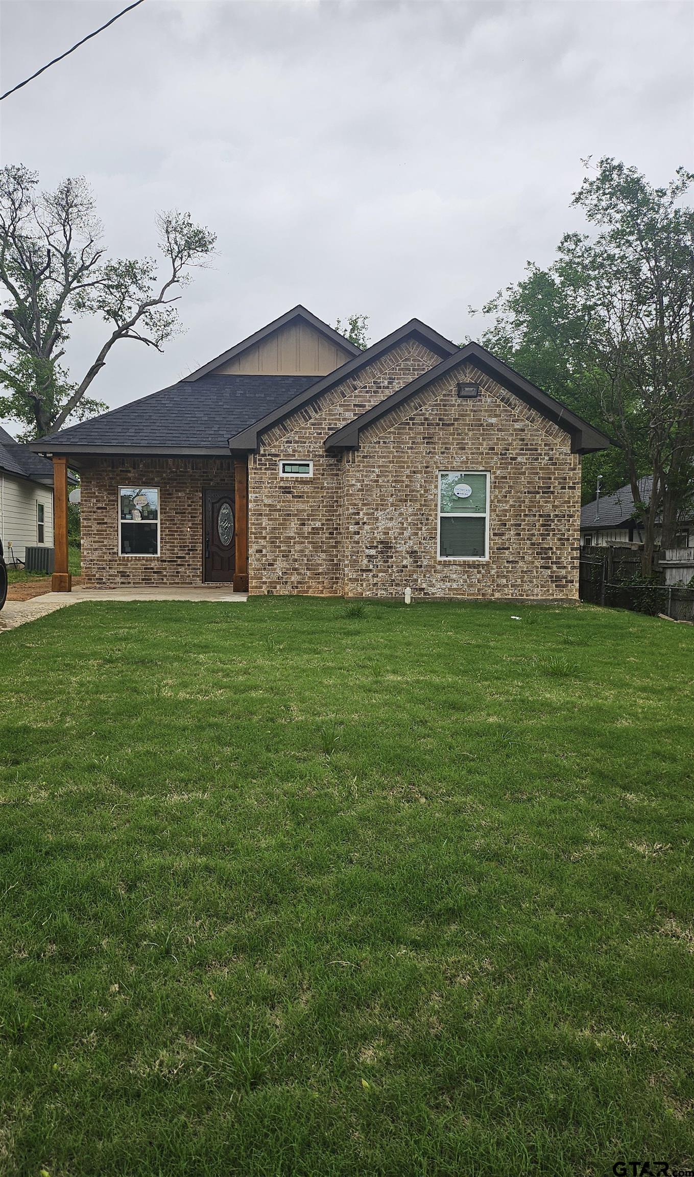 1399 West 2nd Tyler, TX 75701 - Photo 2 of 11 a brick house with a yard