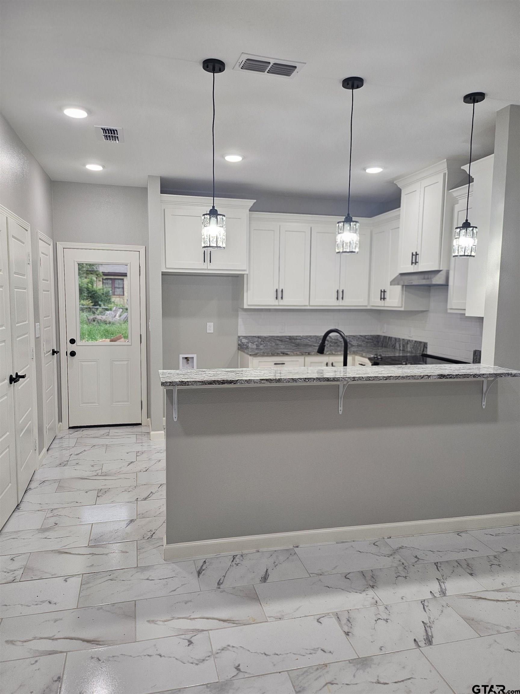 1399 West 2nd Tyler, TX 75701 - Photo 3 of 11 a view of kitchen with stainless steel appliances granite countertop cabinets and window