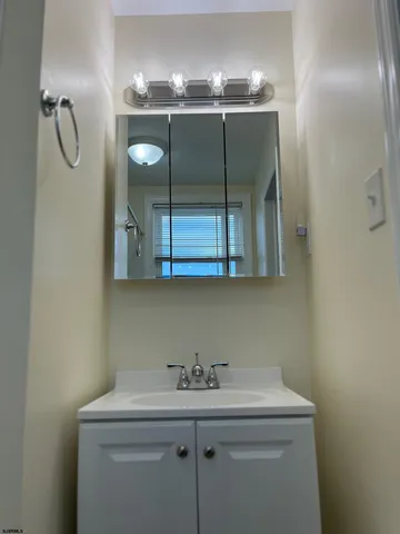 a bathroom with a sink and mirror