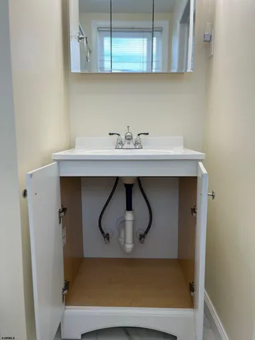 a sink with white cabinets
