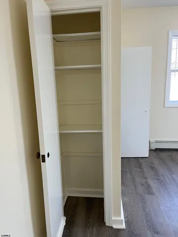 a view of walk in closet with empty racks