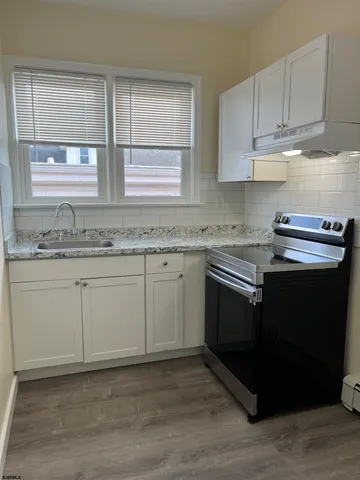 a kitchen with appliances cabinets and a sink