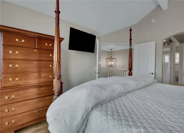 a bedroom with a bed and a mirror
