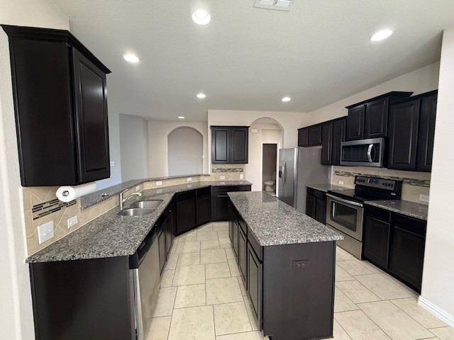1109 Tabernash Leander, TX 78641 - Photo 5 of 23 a kitchen with stainless steel appliances granite countertop a sink stove and refrigerator