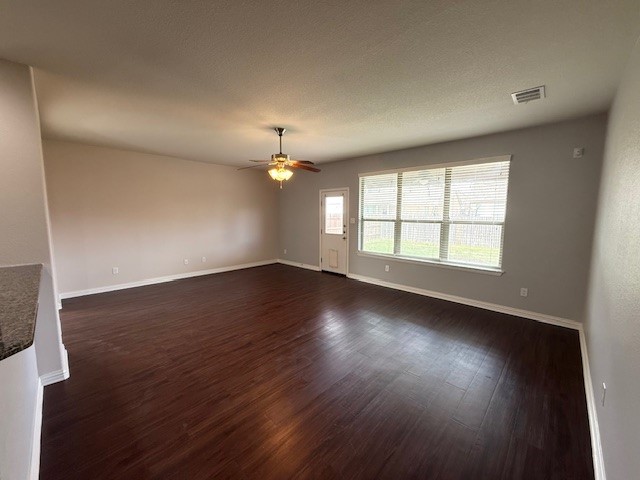 1109 Tabernash Leander, TX 78641 - Photo 6 of 23 an empty room with wooden floor chandelier fan and windows