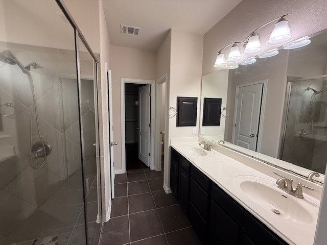 1109 Tabernash Leander, TX 78641 - Photo 10 of 23 a bathroom with a double vanity sink a mirror and a shower