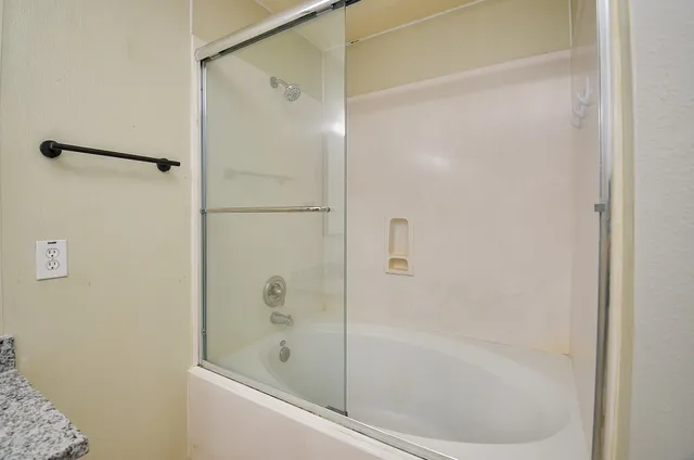 a bathroom with a glass shower door