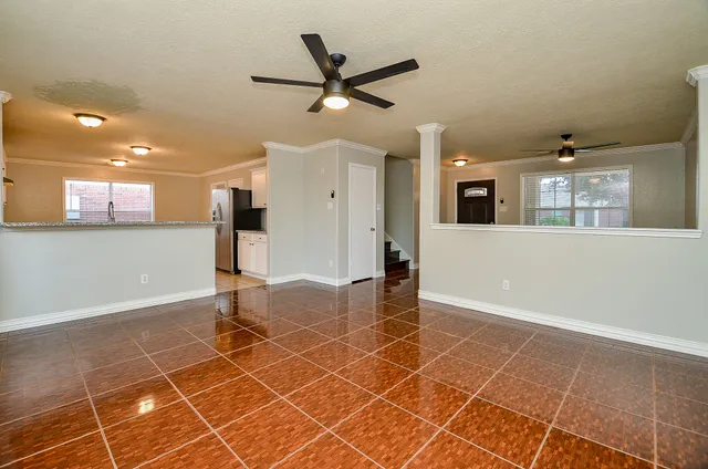 a view of a livingroom with a furniture and ceiling fan