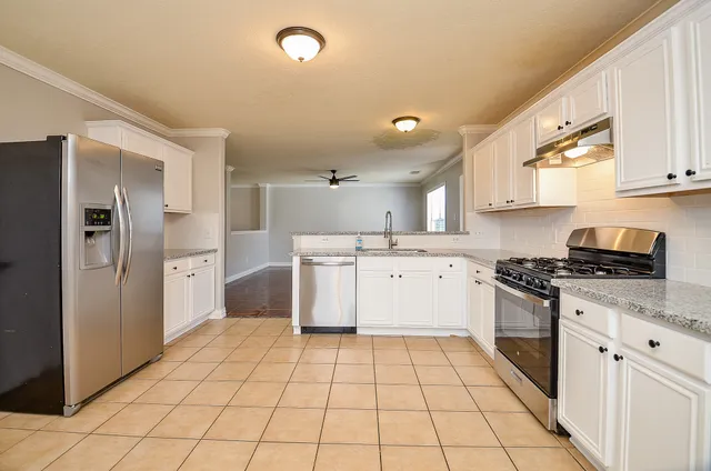 a kitchen with a stove a sink and a refrigerator