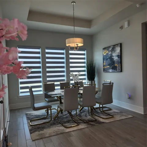a view of a dining room with furniture window and wooden floor