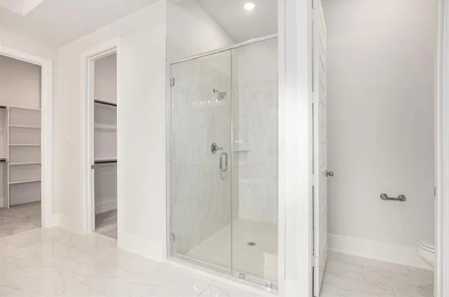 a bathroom with a glass shower door