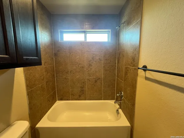 a bathroom with a bathtub and shower