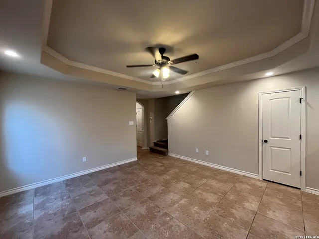 a view of a livingroom with a ceiling fan and chandelier fan
