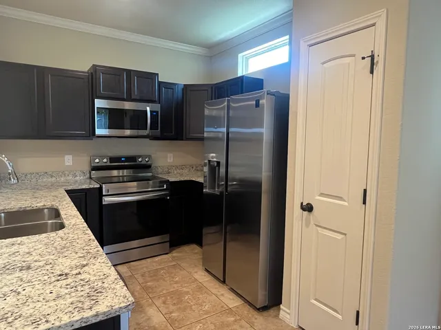 a kitchen with a refrigerator stove and microwave