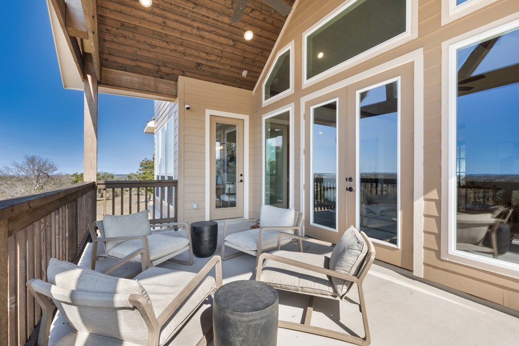 517 Dancing Sun Road Fredericksburg, TX 78624 - Photo 25 of 37 a view of a patio with a dining table and chairs with wooden floor