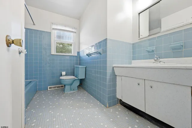 a view of a house with a patio and a yard