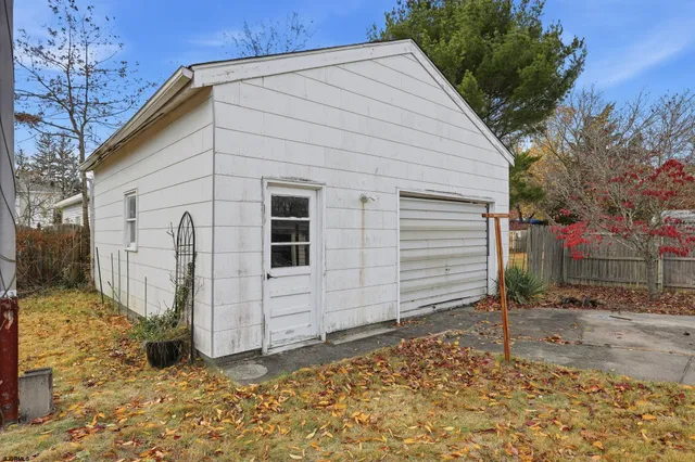 a view of a house with a yard and a garage