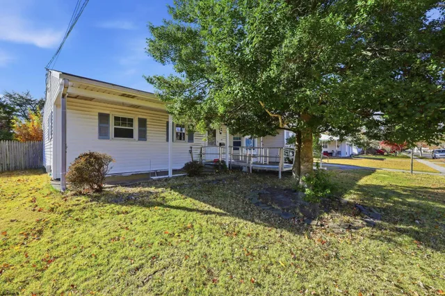 a backyard of a house with a garden and tree