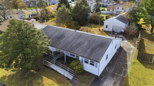an aerial view of a house with a backyard
