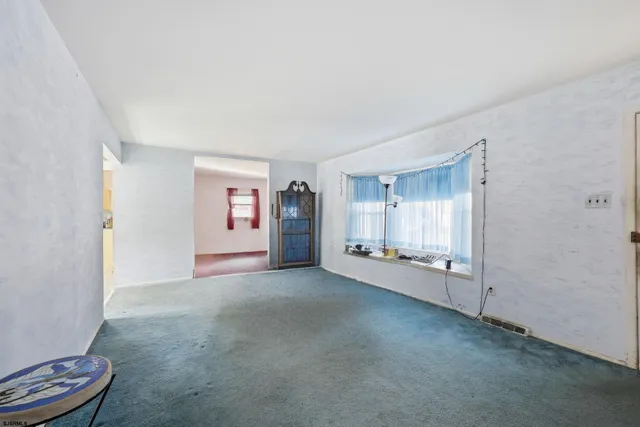 an empty room with a fireplace and painted walls