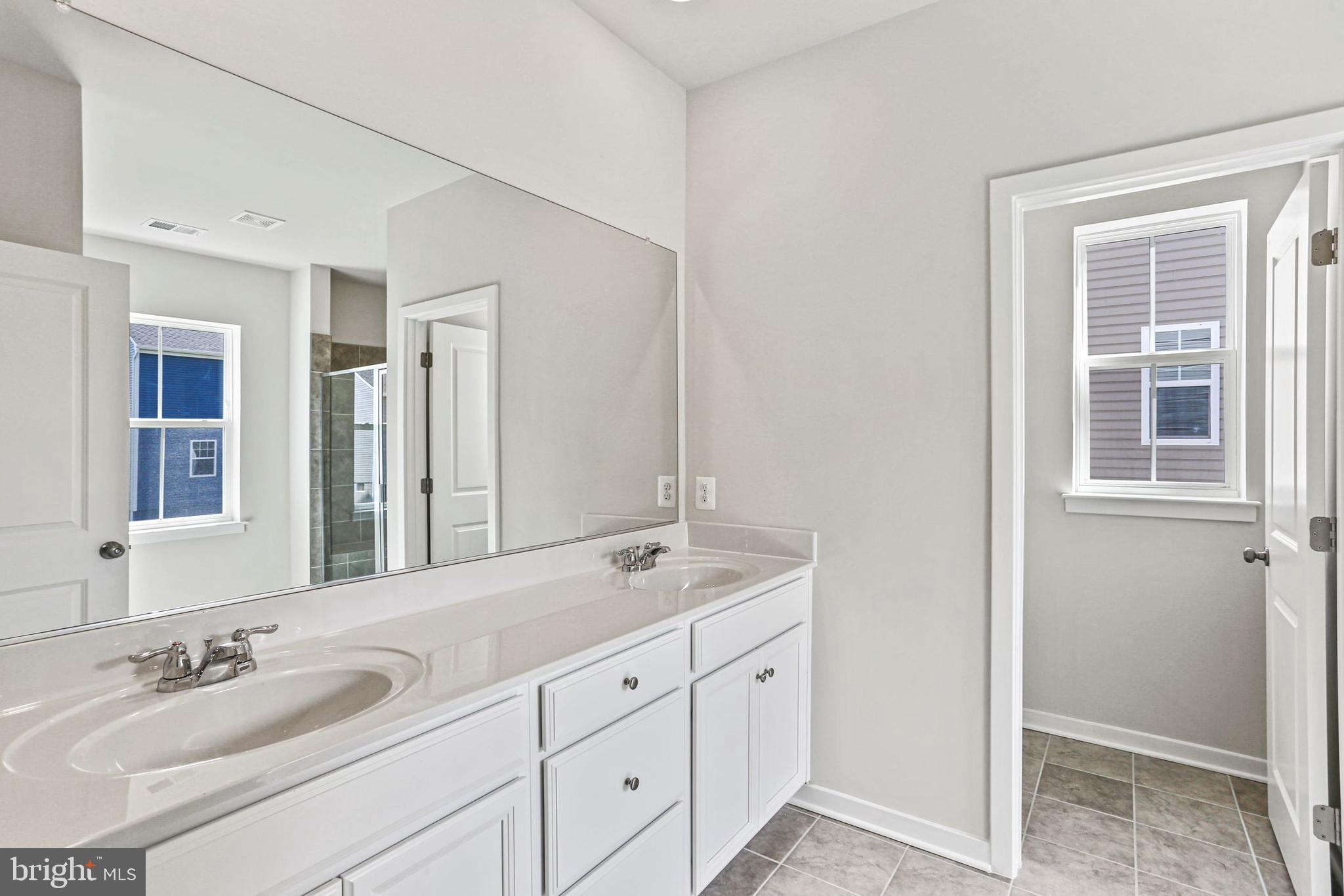 Shenandoah Springs, Unit PRIMROSE Ranson, WV 25438 - Photo 19 of 23 a bathroom with double sink and a mirror