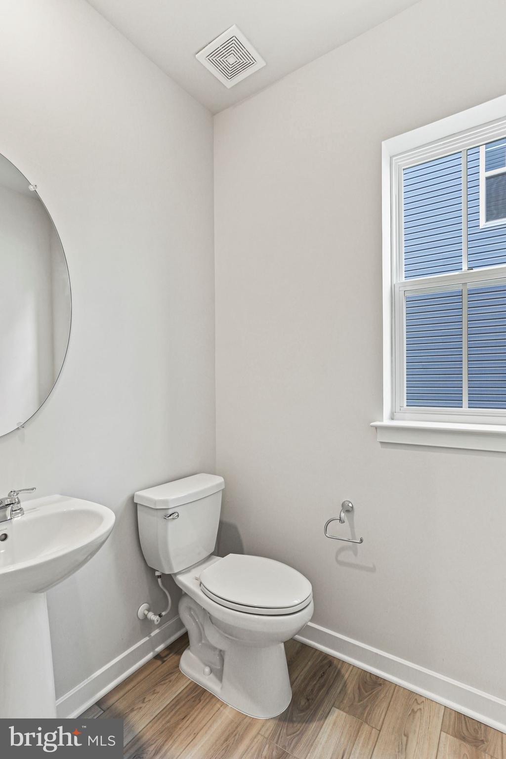Shenandoah Springs, Unit PRIMROSE Ranson, WV 25438 - Photo 7 of 23 a white toilet sitting next to a bathroom sink