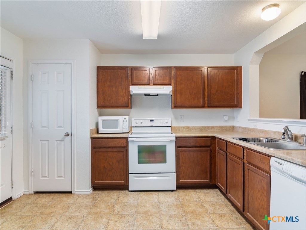 244 Cactus Patch Schertz, TX 78154 - Photo 12 of 23 a kitchen with stainless steel appliances granite countertop a stove and a sink