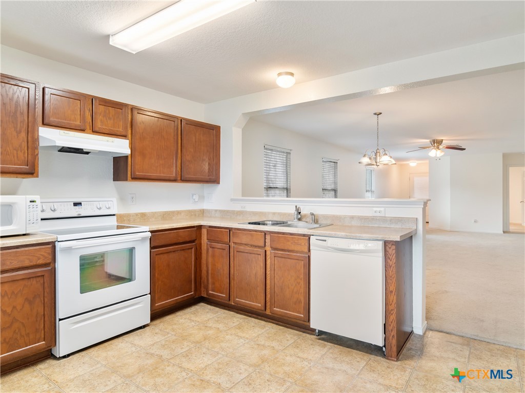 244 Cactus Patch Schertz, TX 78154 - Photo 13 of 23 a kitchen with granite countertop white cabinets stainless steel appliances and a sink