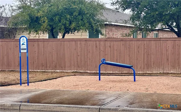 a view of a bench in the backyard