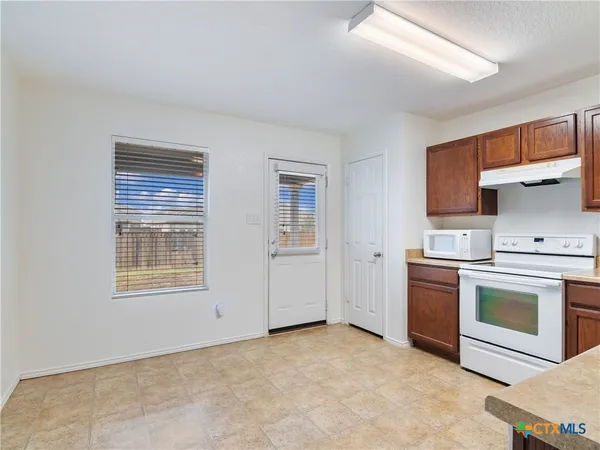 a kitchen with a stove oven and a refrigerator