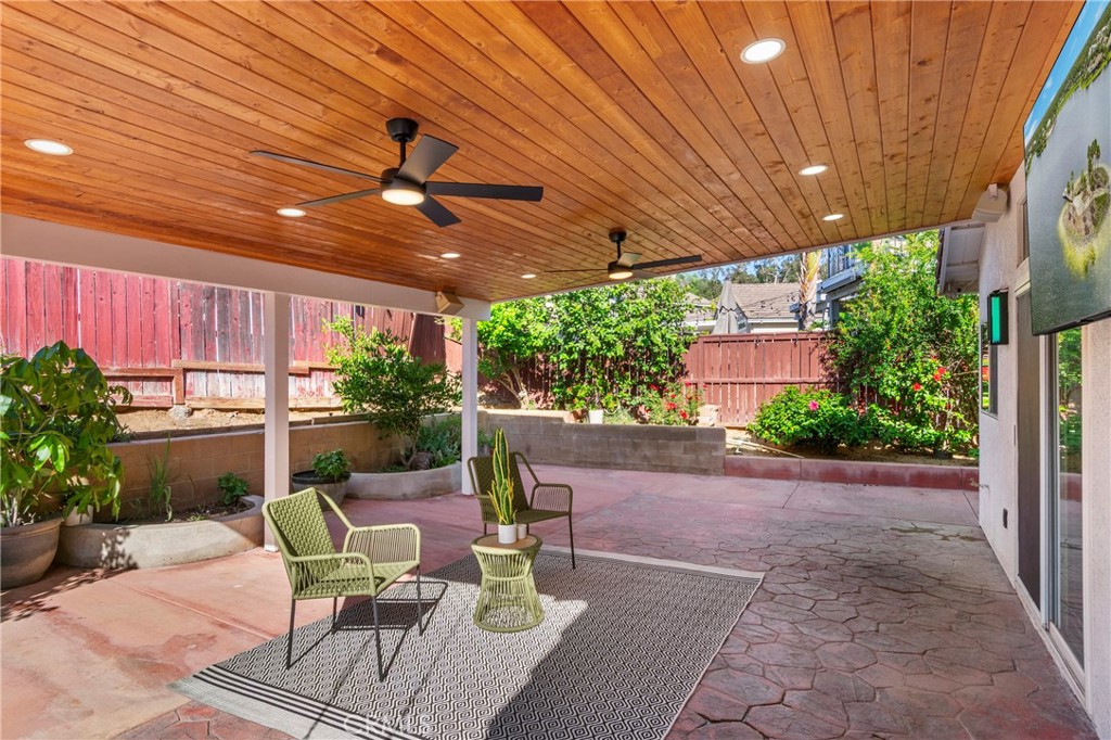 16366 West Sun Canyon Street Riverside, CA 92503 - Photo 18 of 21 a view of a patio with table and chairs potted plants with wooden floor