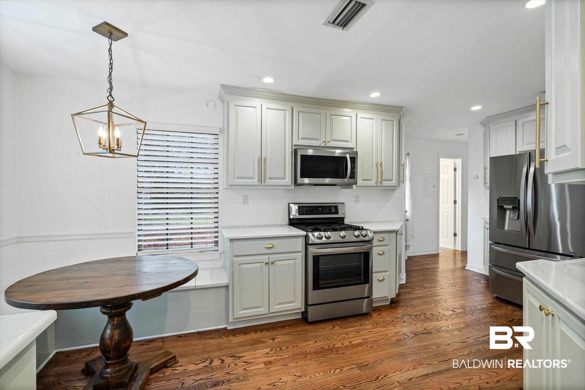 11 York Place Mobile, AL 36608 - Photo 7 of 24 Kitchen featuring appliances with stainless steel finishes, hanging light fixtures, dark wood-style flooring, recessed lighting, and gray cabinets