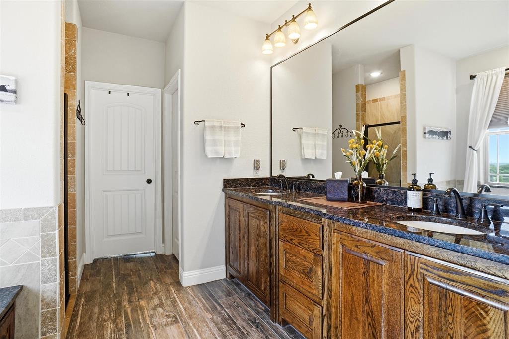 1024 Tex Lane Springtown, TX 76082 - Photo 22 of 40 a view of a bathroom with a sink and mirror