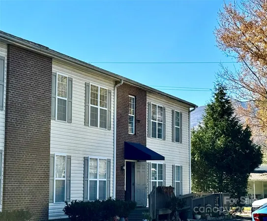 a front view of a house with plants