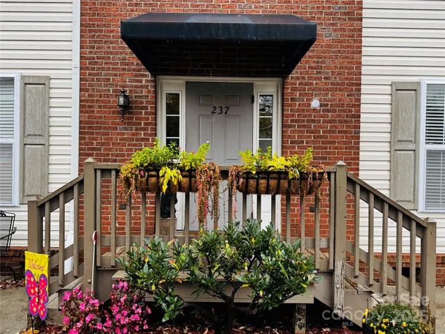 a front view of a house with outdoor seating