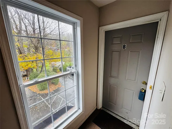 view of an empty room with wooden floor and windows