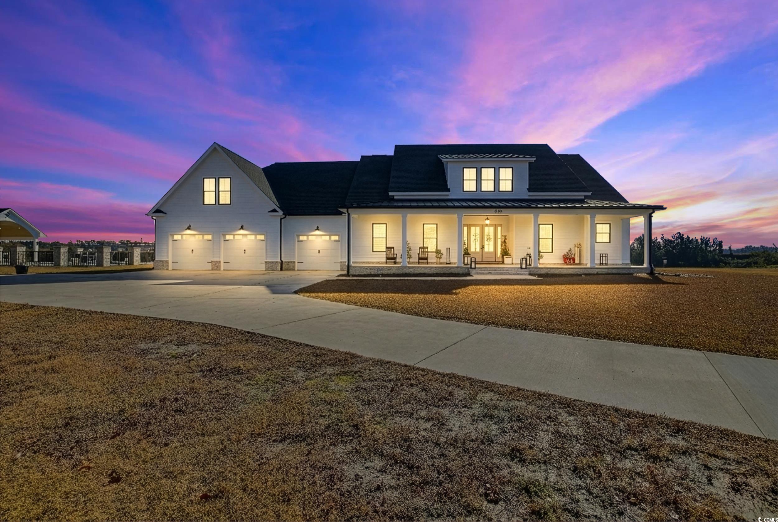 280 Bay Rdg Drive North Myrtle Beach, SC 29582 - Photo 1 of 38 Modern inspired farmhouse with a porch, driveway, a standing seam roof, a garage, and a metal roof