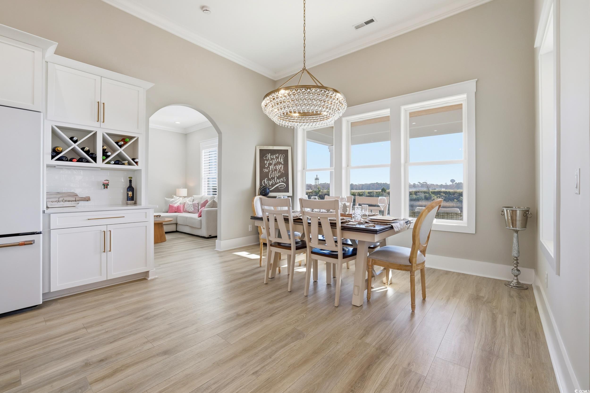 280 Bay Rdg Drive North Myrtle Beach, SC 29582 - Photo 13 of 38 Dining room with crown molding, light wood finished floors, and a chandelier