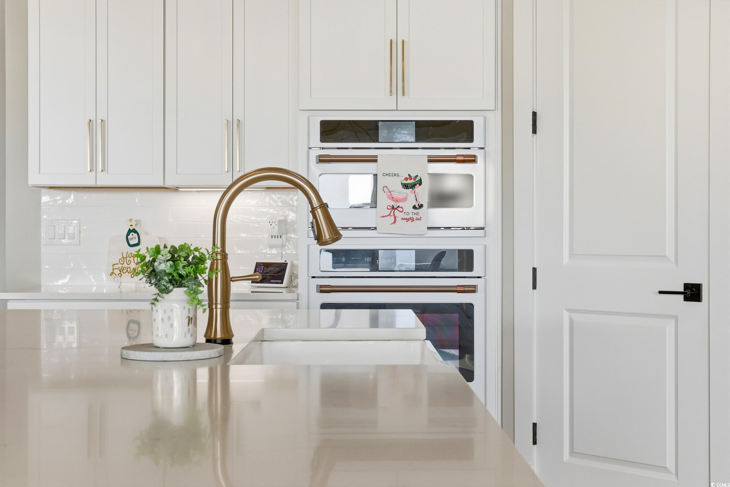 280 Bay Rdg Drive North Myrtle Beach, SC 29582 - Photo 14 of 38 Kitchen featuring white cabinets, double oven, light stone counters, and backsplash
