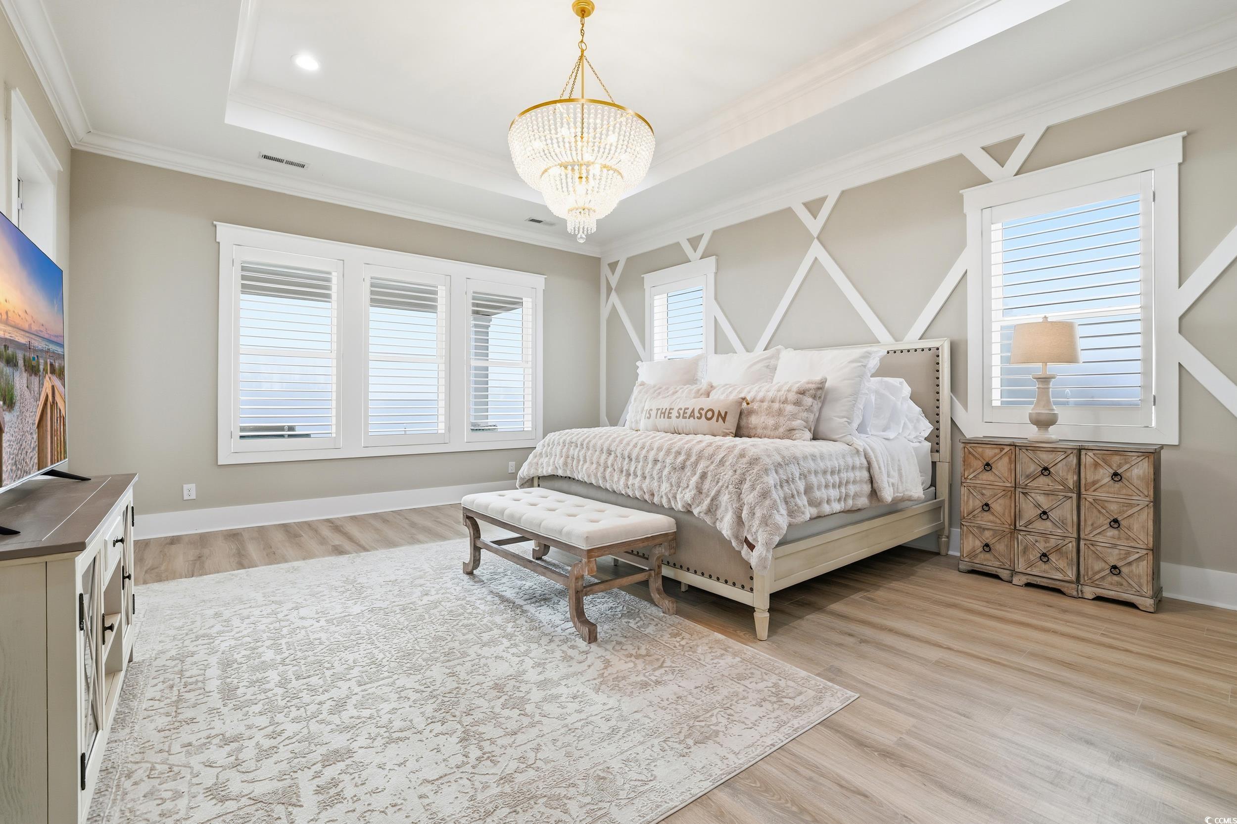 280 Bay Rdg Drive North Myrtle Beach, SC 29582 - Photo 19 of 38 Bedroom featuring light wood-type flooring, multiple windows, crown molding, a chandelier, and a tray ceiling