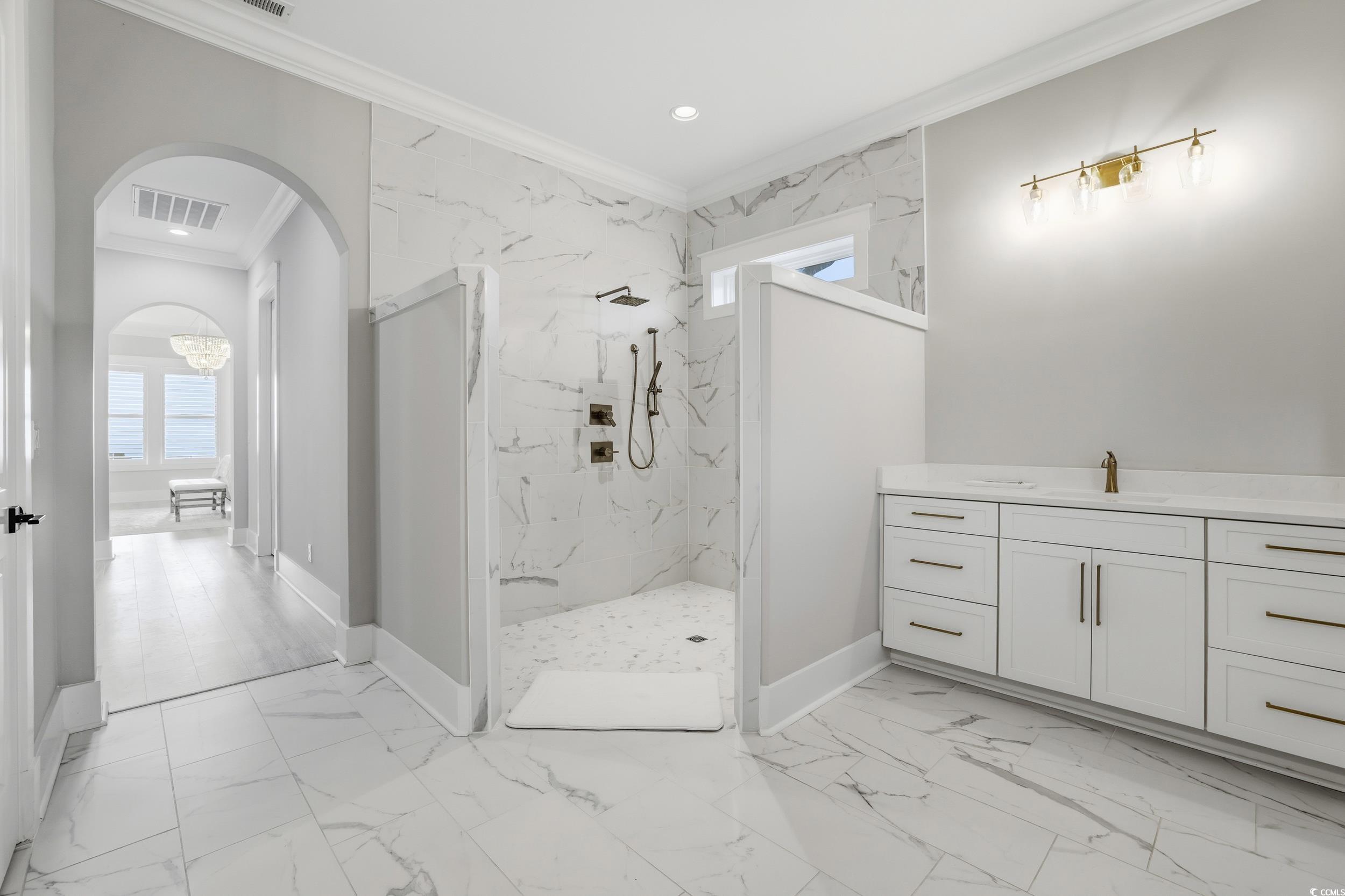280 Bay Rdg Drive North Myrtle Beach, SC 29582 - Photo 20 of 38 Bathroom featuring plenty of natural light, ornamental molding, light marble finish floors, and a marble finish shower