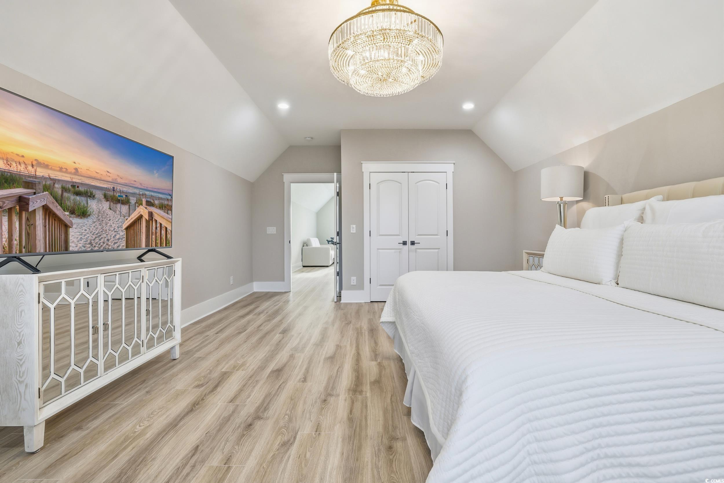 280 Bay Rdg Drive North Myrtle Beach, SC 29582 - Photo 23 of 38 Bedroom with lofted ceiling, light wood-style floors, recessed lighting, a closet, and a chandelier