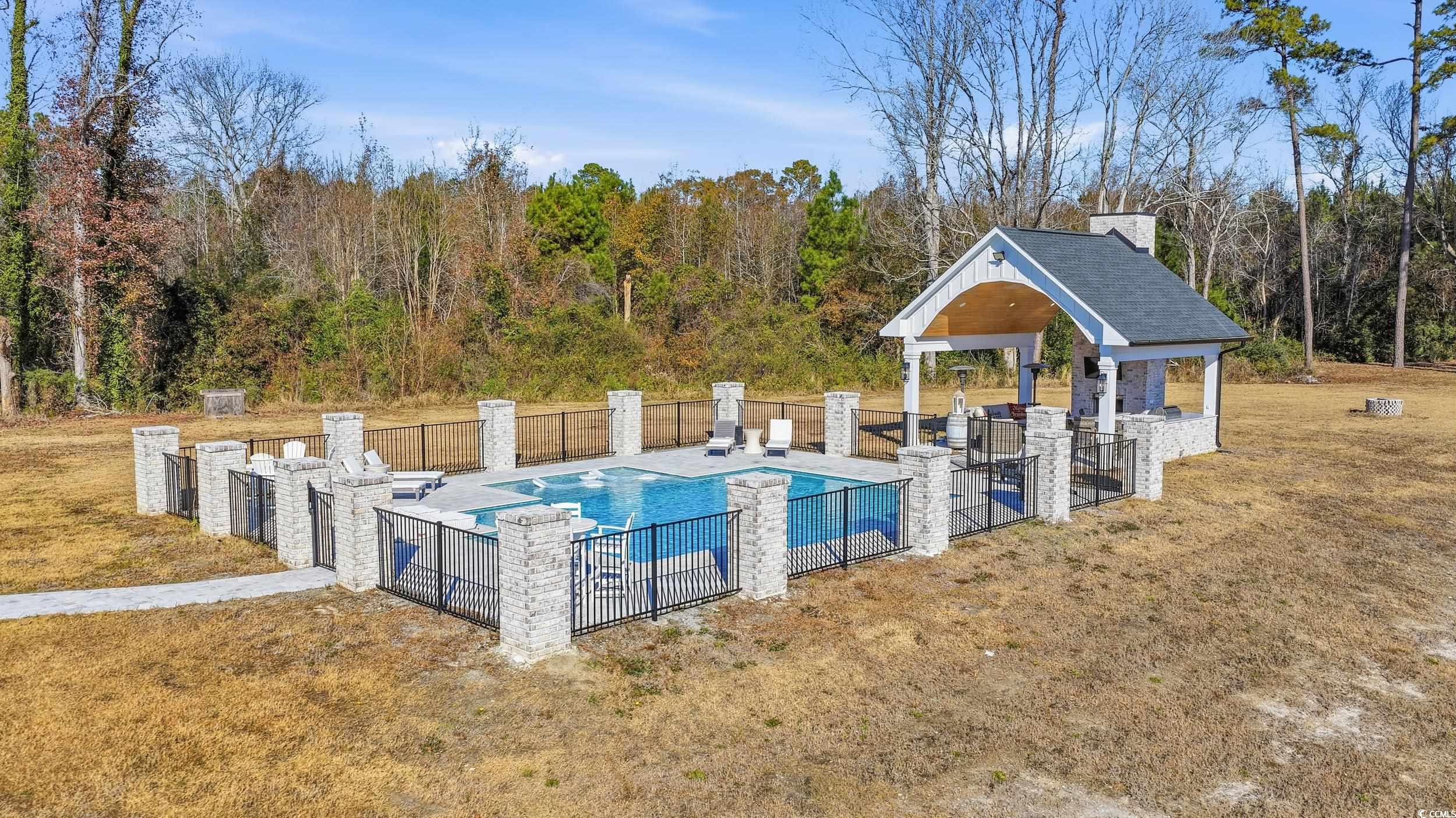 280 Bay Rdg Drive North Myrtle Beach, SC 29582 - Photo 32 of 38 View of swimming pool with a patio area and a wooded view