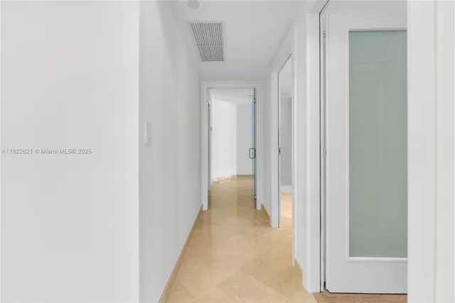 a view of a hallway with a wooden table