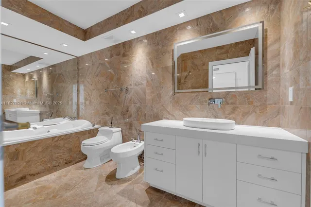 a bathroom with a double vanity sink mirror and toilet