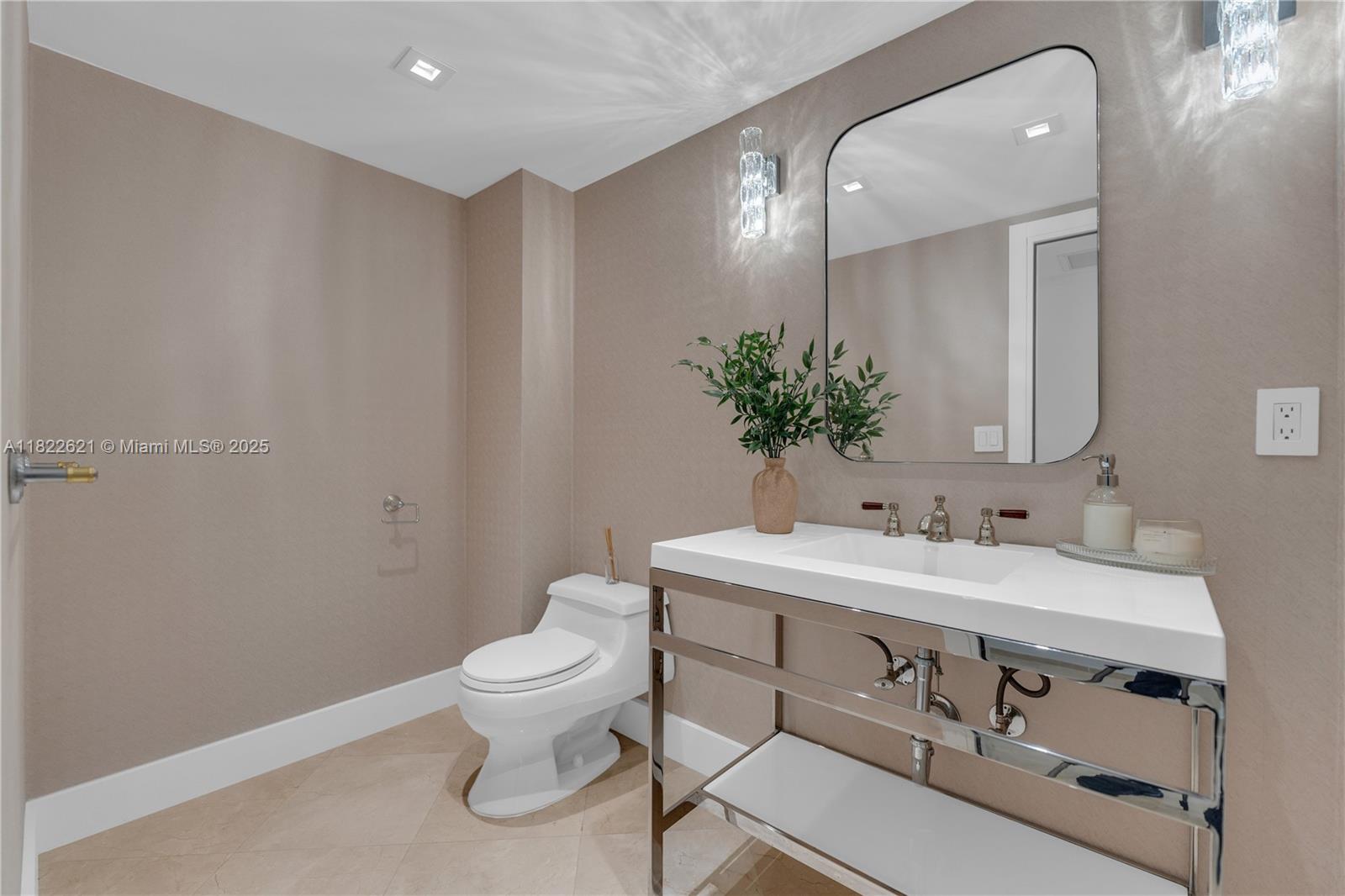 9801 Collins Avenue, Unit 16Y Bal Harbour, FL 33154 - Photo 8 of 17 a bathroom with a toilet a sink and mirror