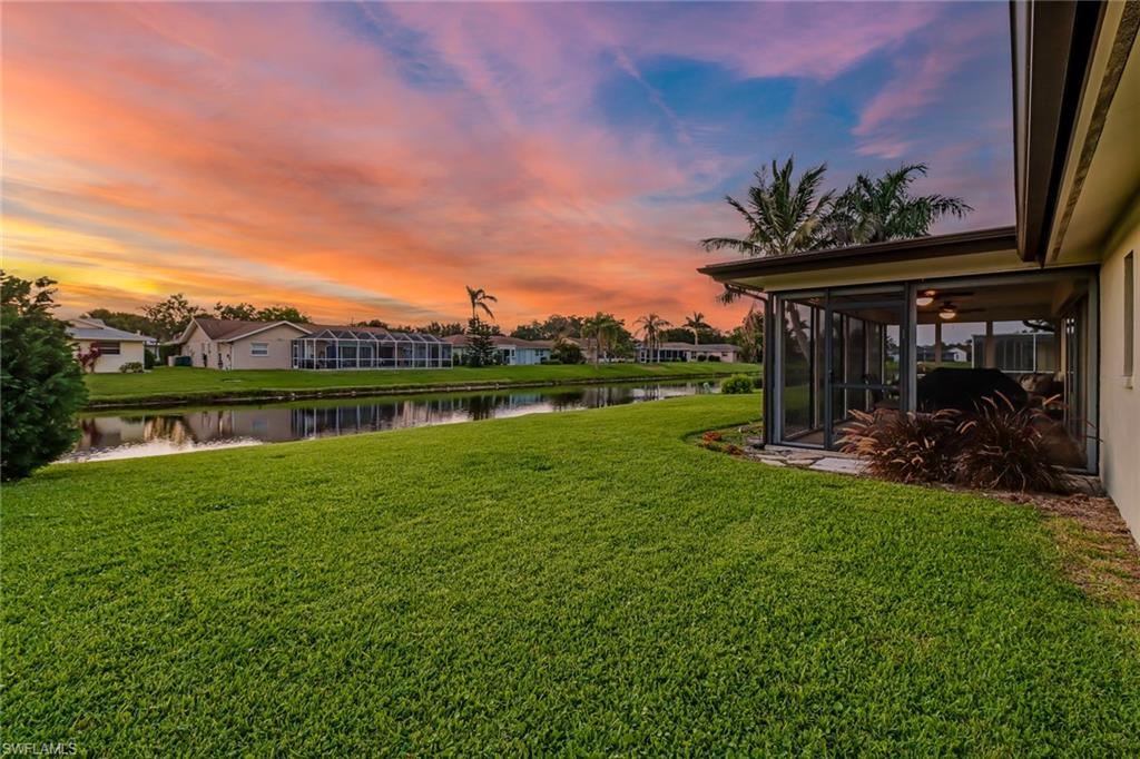 4576 Eagle Key Circle Naples, FL 34112 - Photo 15 of 18 a view of a garden with a bench in the background