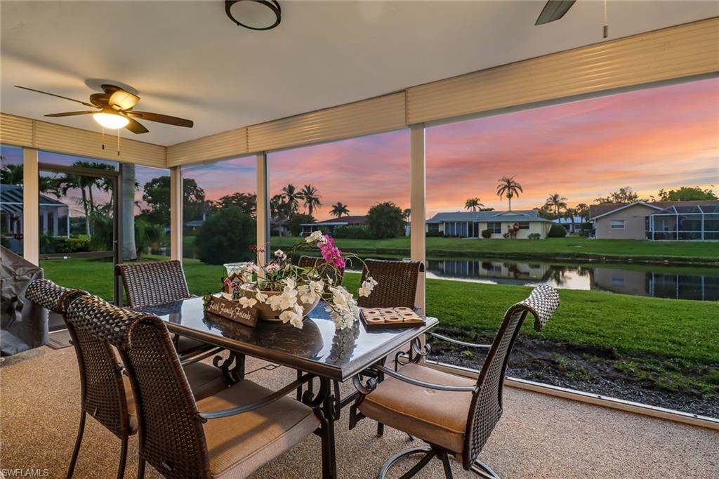 4576 Eagle Key Circle Naples, FL 34112 - Photo 18 of 18 a view of a patio with a table chairs and a floor to ceiling window