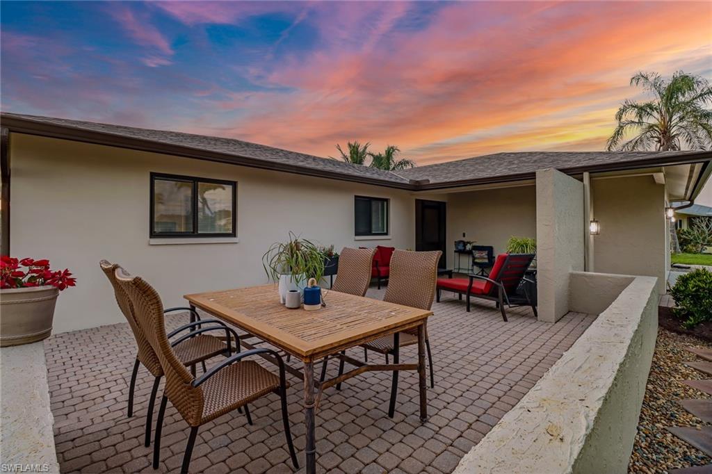 4576 Eagle Key Circle Naples, FL 34112 - Photo 2 of 18 a view of a dinning table and chairs in patio of the house